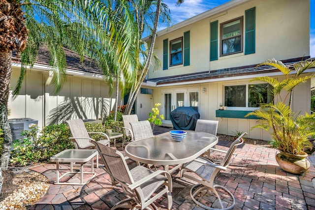 view of patio featuring french doors, area for grilling, and central air condition unit