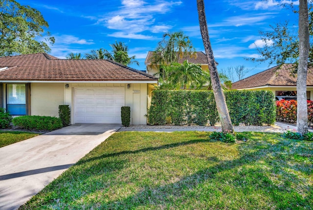 ranch-style home with a garage and a front lawn