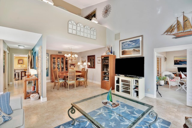 living room with a notable chandelier, light tile patterned flooring, and a high ceiling