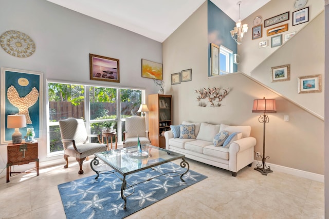 tiled living room with a towering ceiling and a chandelier