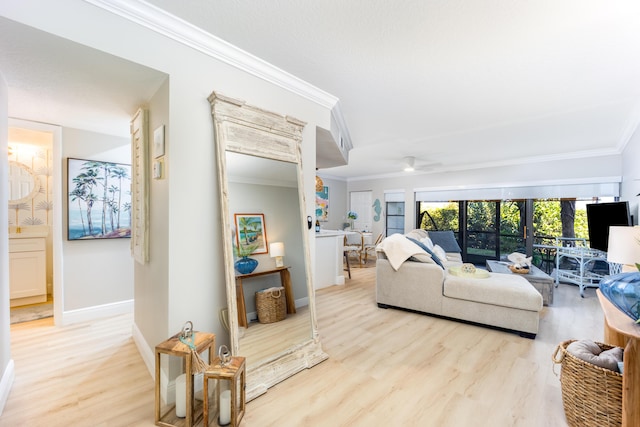 living room with ceiling fan, ornamental molding, and light hardwood / wood-style flooring