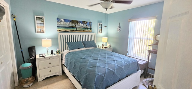 tiled bedroom featuring ceiling fan