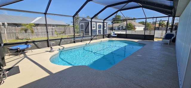 view of pool with a storage unit, a lanai, and a patio area