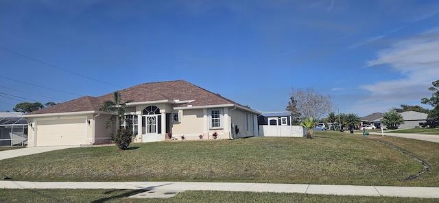 view of front of house with a garage and a front lawn