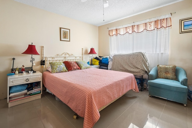 bedroom featuring tile patterned floors and a textured ceiling