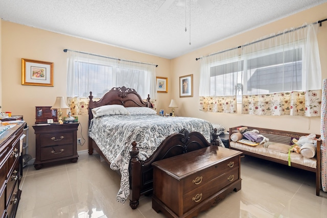 tiled bedroom with multiple windows and a textured ceiling