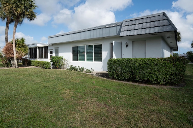 view of property exterior with a yard