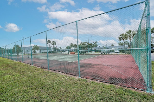 view of sport court featuring a lawn