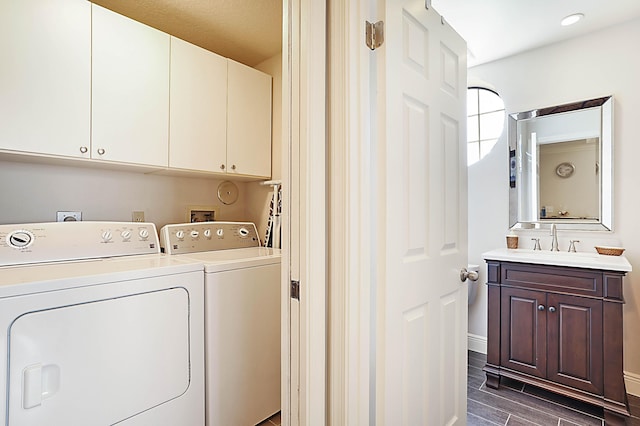 laundry room featuring cabinets, washer and clothes dryer, and sink