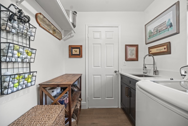 laundry room with cabinets, washer / clothes dryer, dark hardwood / wood-style flooring, and sink