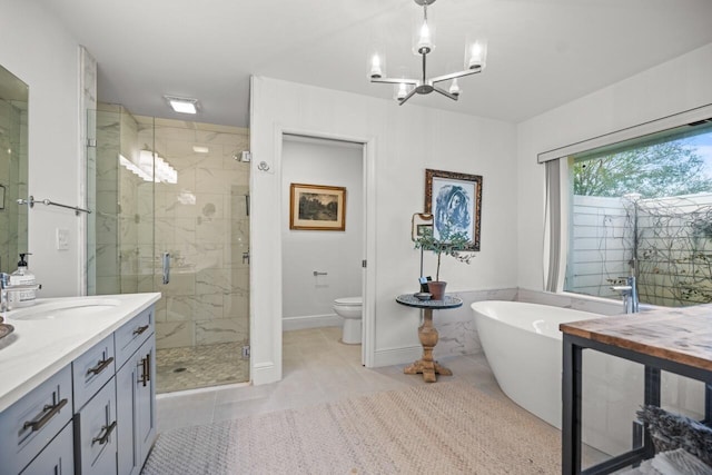 full bathroom with separate shower and tub, vanity, a notable chandelier, tile patterned floors, and toilet