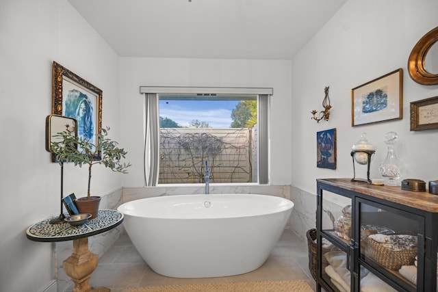 bathroom featuring tile patterned flooring and a bathing tub