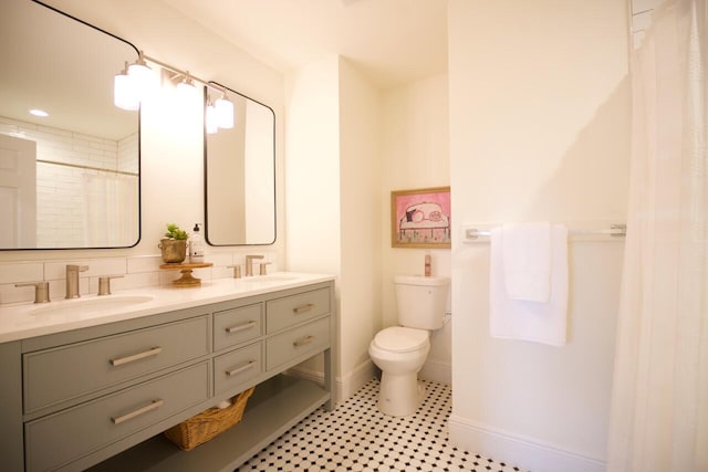 bathroom with vanity, curtained shower, tasteful backsplash, and toilet