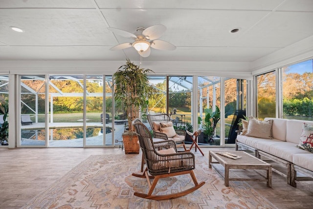 sunroom / solarium featuring ceiling fan