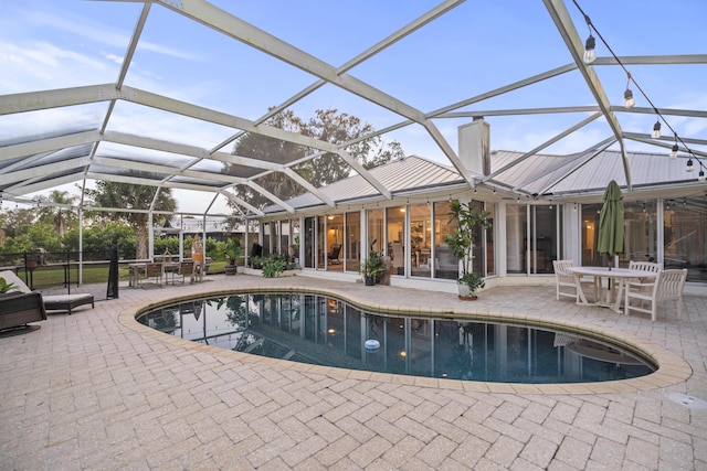 view of swimming pool with a lanai and a patio