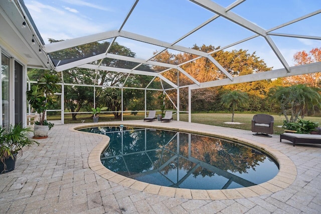 view of swimming pool with a patio and a lanai