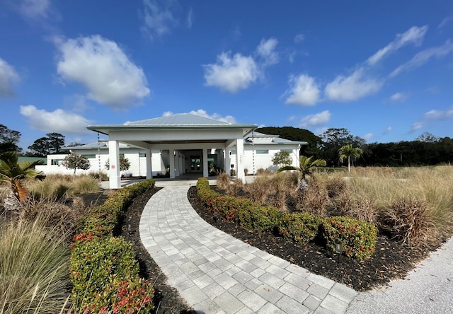 back of property with a carport