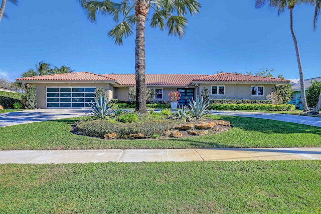 ranch-style house featuring a garage and a front lawn