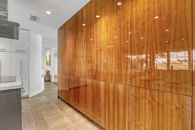 corridor featuring light tile patterned floors