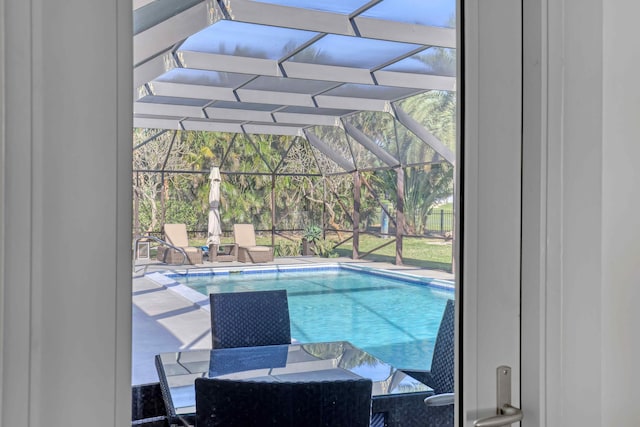 view of pool featuring a patio and glass enclosure