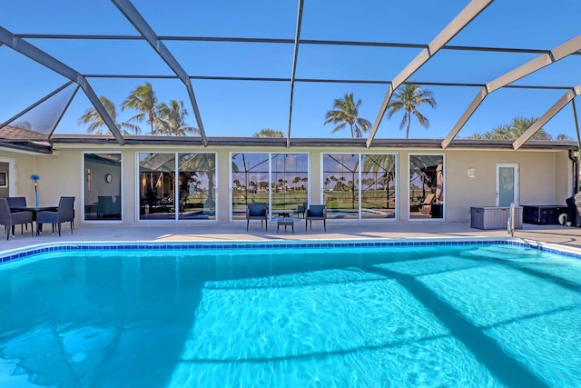 view of swimming pool with a patio area and glass enclosure