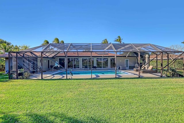 rear view of property with a patio, a lanai, and a lawn