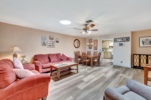 living room with light hardwood / wood-style floors and ceiling fan