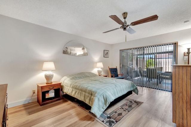 bedroom with ceiling fan, access to outside, a textured ceiling, and light hardwood / wood-style flooring