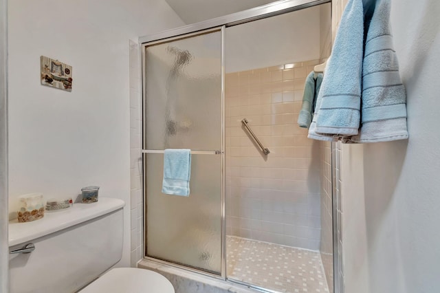 bathroom featuring an enclosed shower and toilet