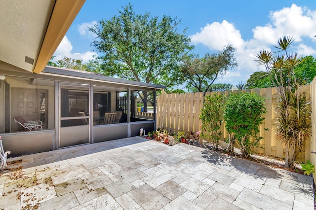 view of patio featuring a sunroom