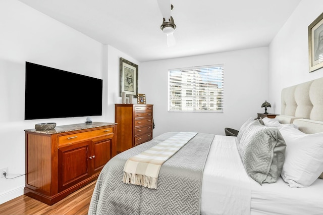 bedroom with light hardwood / wood-style floors and ceiling fan