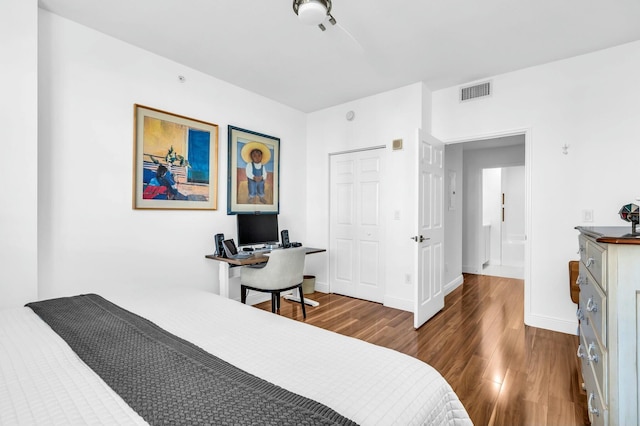 bedroom with dark wood-type flooring