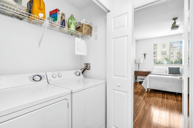 laundry area with independent washer and dryer and hardwood / wood-style floors