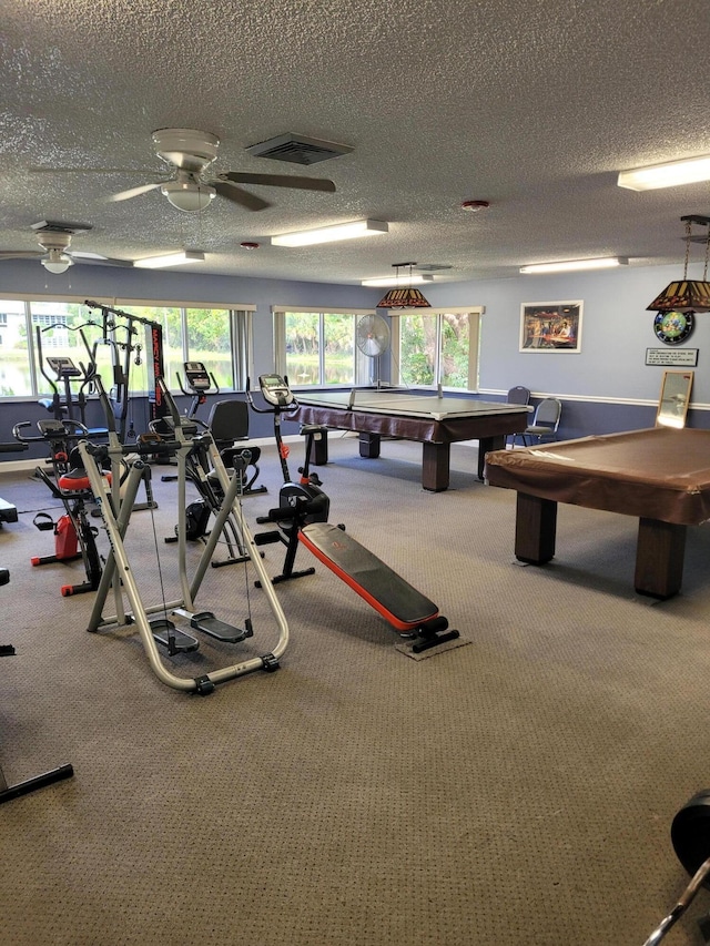 workout area with carpet flooring, pool table, and a textured ceiling