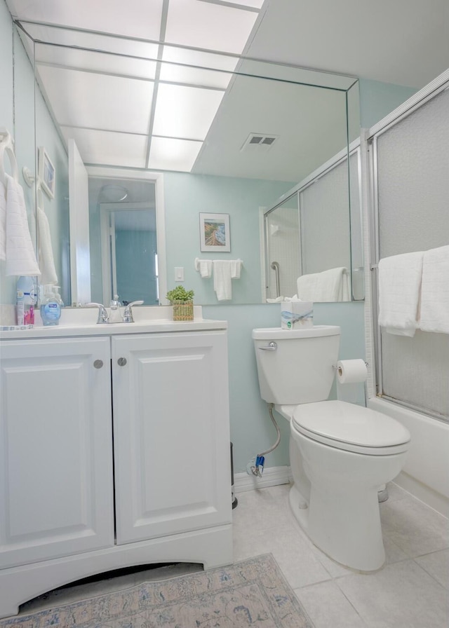 full bathroom with vanity, combined bath / shower with glass door, tile patterned floors, and toilet