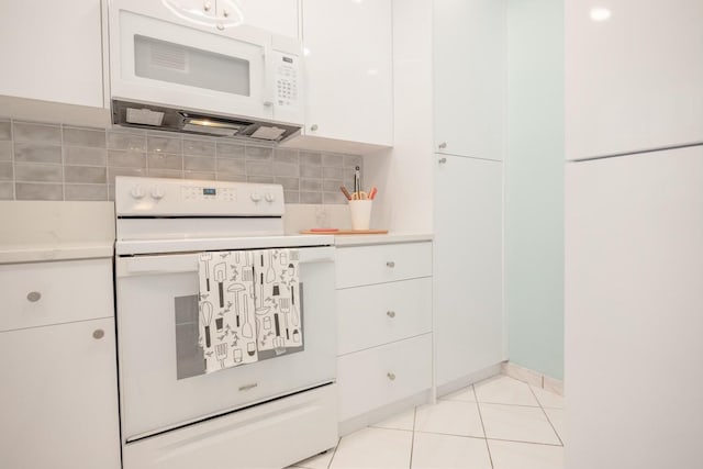 kitchen with white cabinetry, light tile patterned floors, white appliances, and decorative backsplash