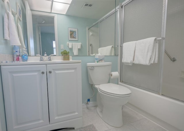 full bathroom with vanity, combined bath / shower with glass door, tile patterned floors, and toilet