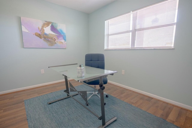 home office with hardwood / wood-style floors