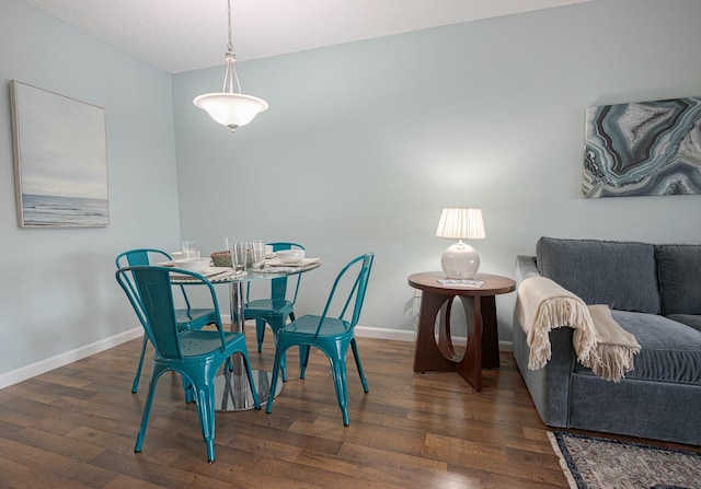 dining space featuring dark wood-type flooring