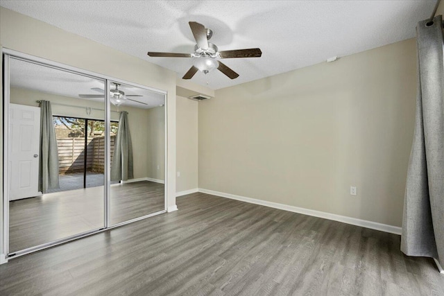 unfurnished room featuring hardwood / wood-style floors and a textured ceiling