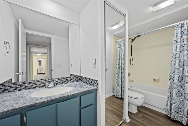 full bathroom with toilet, wood-type flooring, vanity, shower / bath combo with shower curtain, and backsplash