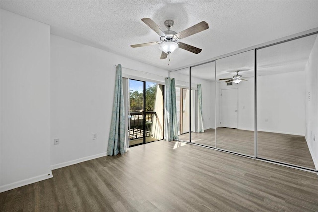 unfurnished bedroom with hardwood / wood-style flooring, ceiling fan, a textured ceiling, and access to outside