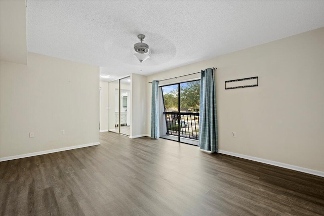 spare room featuring ceiling fan, a textured ceiling, and dark hardwood / wood-style flooring