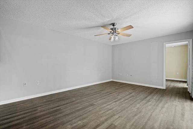 unfurnished room with ceiling fan, dark wood-type flooring, and a textured ceiling