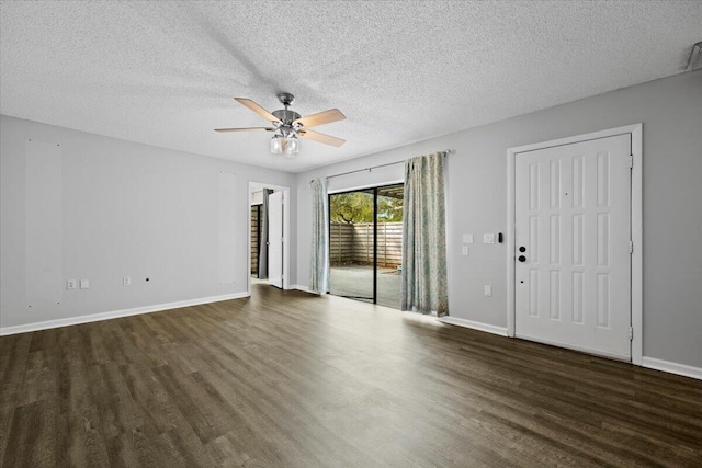 interior space featuring dark wood-type flooring, a textured ceiling, and ceiling fan