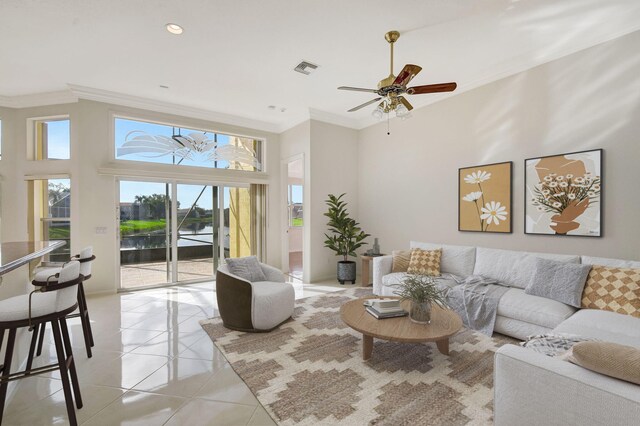 living room with decorative columns, crown molding, light tile patterned floors, and ceiling fan