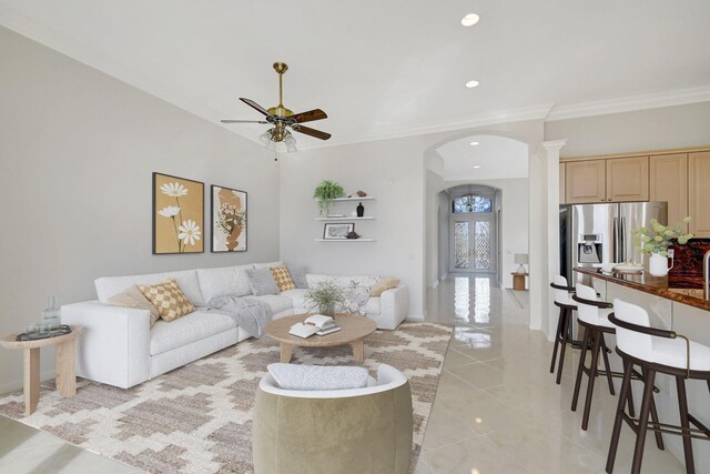 kitchen with an island with sink, a kitchen breakfast bar, decorative backsplash, stainless steel appliances, and crown molding