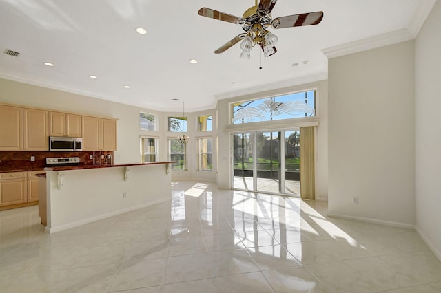 kitchen with baseboards, ornamental molding, stainless steel appliances, tasteful backsplash, and open floor plan