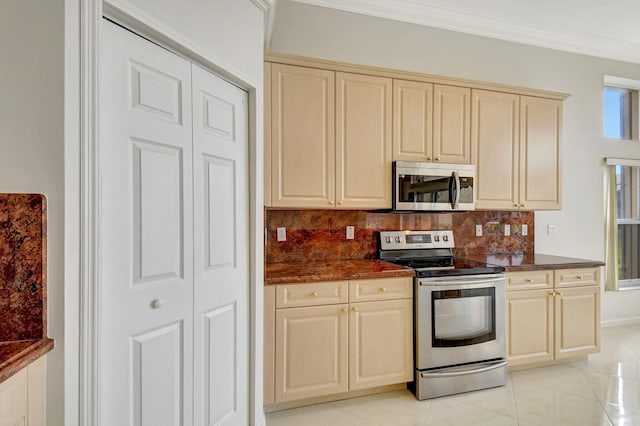 kitchen featuring dark countertops, crown molding, backsplash, and stainless steel appliances