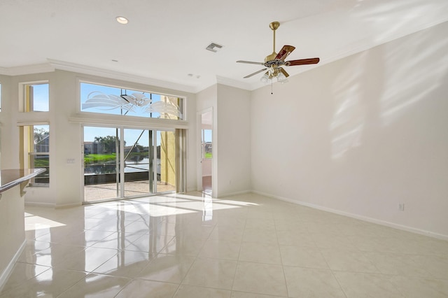 tiled empty room with a water view, ceiling fan, and ornamental molding